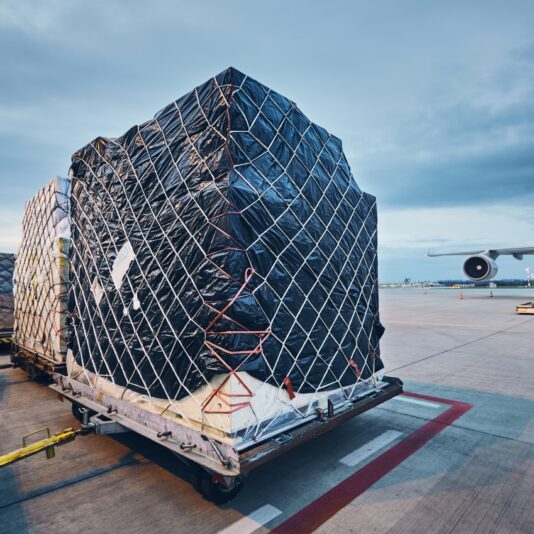 Loading cargo to airplane Airport at dusk. Loading of airplane before flight.